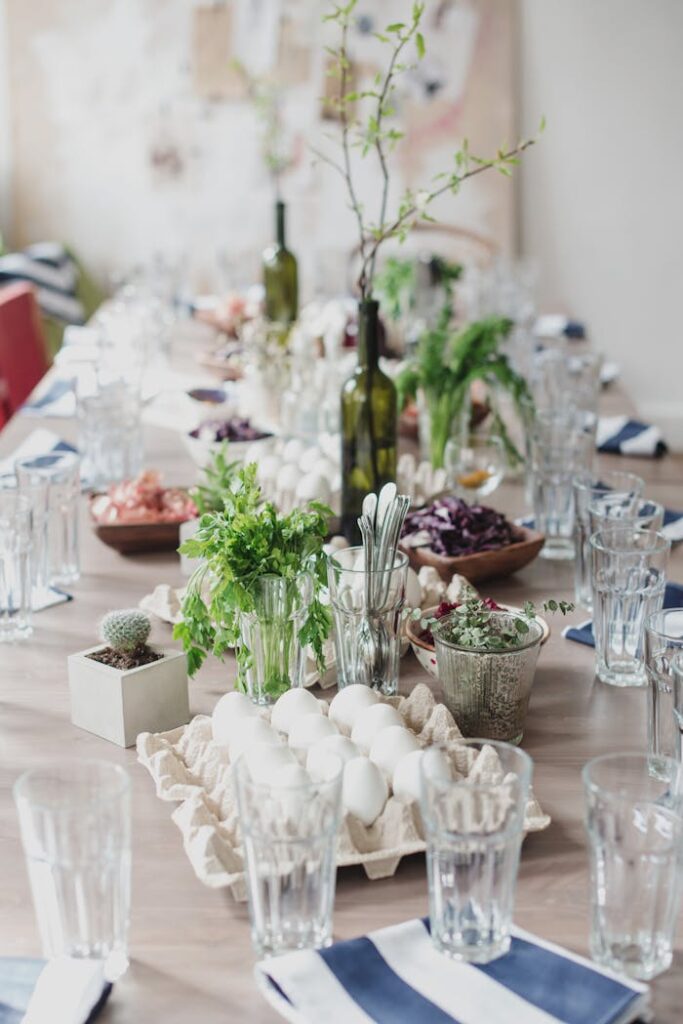 Creative table setting for celebration of Easter with green tree branches in vine bottles